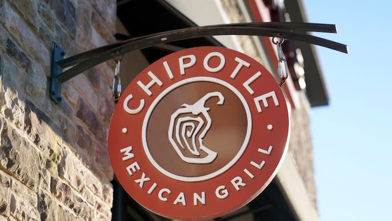 A Chipotle Mexican Grill logo hangs outside a restaurant location, Tuesday, Dec. 20, 2022, in Westwood, Mass. TikTok users are filming themselves walking out of Chipotle midorder as a way to boycott the popular fast-food chain.