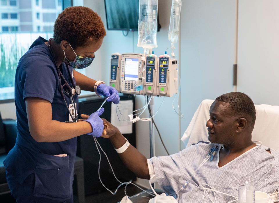 Transplant RN Auyana Smith helps patient Stephen O'Neal after his kidney transplant on Tuesday, June 7, 2022, at Methodist University Hospital in Memphis.