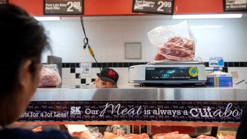 A bag of meat is weighed at the Glendale Super King market's butcher counter.