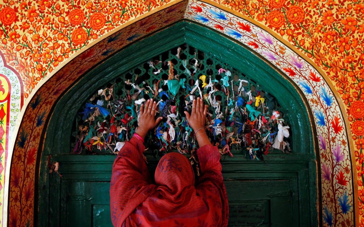 A woman prays at the shrine of Sufi Saint Khawaja Naqshband during the holy fasting month of Ramadan in Srinagar last year - REUTERS