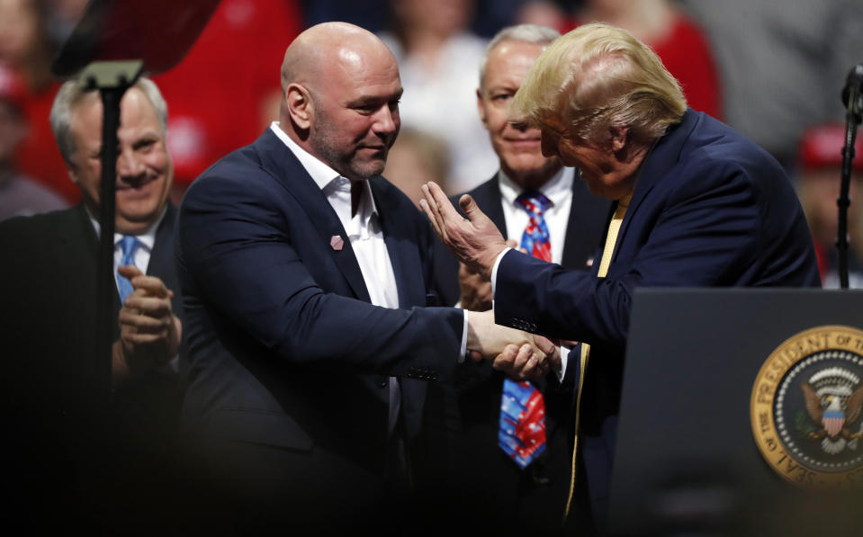 President Donald Trump, right, greets Dana White, head of the Ultimate Fighting Championship, at a campaign rally Thursday, Feb. 20, 2020, in Colorado Springs, Colo. (AP Photo/David Zalubowski)