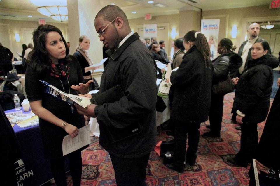 Daniela Silvero, left, an admissions officer at ASA College, discusses job opportunities with Patrick Rosarie, who is seeking a job in IT, during JobEXPO's job fair on Wednesday, Jan. 25, 2012 in New York. The number of people seeking unemployment benefits rose last week, after falling to a nearly four-year low the previous week. (AP Photo/Bebeto Matthews)