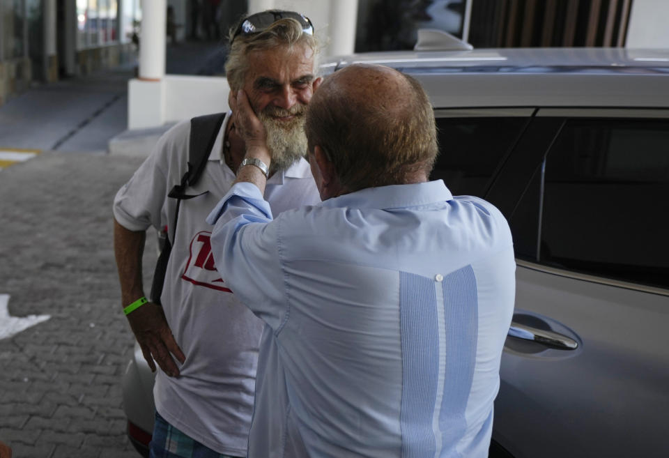 Timothy Shaddock, left, the Australian sailor who spent months adrift in the Pacific Ocean before being rescued by a Mexican tuna boat, speaks with Grupo Mar President Antonio Suarez prior an interview in Manzanillo, Mexico, Wednesday, July 19, 2023. Shaddock and his dog left northwest Mexico in a catamaran in late April, he said, planning to sail to French Polynesia, but a few weeks into his voyage, he was struck by a storm, which disabled his catamaran and left him with no electronics and no way to cook. They survived by fishing and drinking rain water. (AP Photo/Fernando Llano)