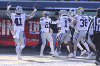 Kansas State players celebrate after a defensive touchdown against West Virginia during the first half of an NCAA college football game in Morgantown, W.Va., Saturday, Nov. 19, 2022. (AP Photo/Kathleen Batten)