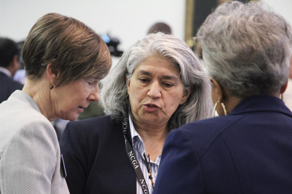 North Carolina state Sen. Lisa Grafstein, center, speaks with fellow Democratic Sens. Joyce Waddell, left, and Gladys Robinson on the Senate floor in Raleigh, N.C., before an abortion vote, Thursday, May 4, 2023. (AP Photo/Hannah Schoenbaum)