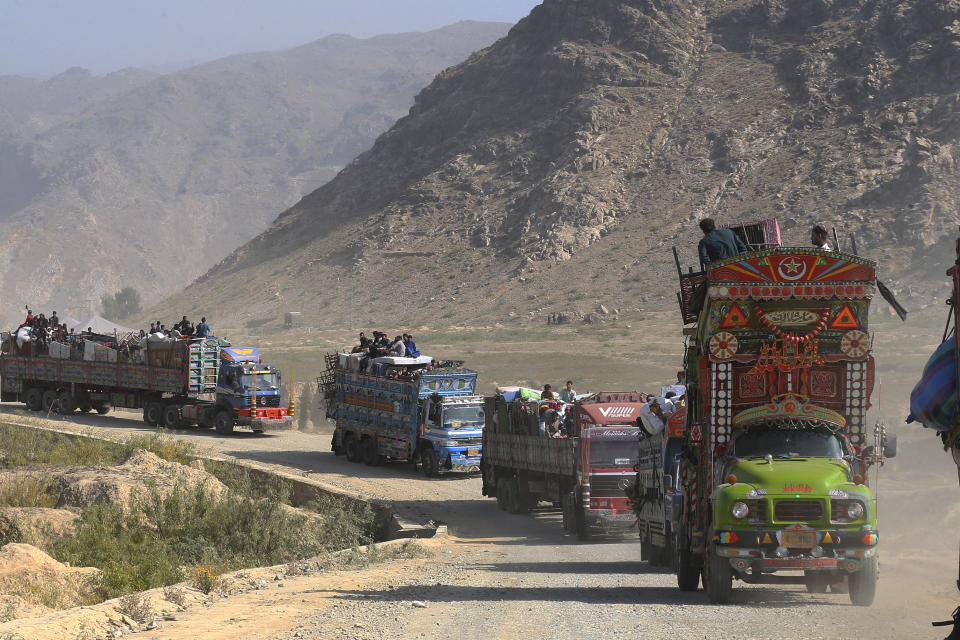 FILE - A convey of trucks carrying Afghan families drive toward a border crossing point in Torkham, Pakistan, Tuesday, Oct. 31, 2023. For more than 1 million Afghans who fled war and poverty to Pakistan, these are uncertain times. Since Pakistan announced a crackdown on migrants last year, some 600,000 have been deported and at least a million remain in Pakistan in hiding. They've retreated from public view, abandoning their jobs and rarely leaving their neighborhoods out of fear they could be next. It's harder for them to earn money, rent accommodation, buy food or get medical help because they run the risk of getting caught by police or being reported to authorities by Pakistanis. (AP Photo/Muhammad Sajjad, File)