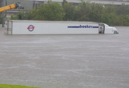 An eighteen wheel tractor trailer is stranded on Interstate highway 45 which is submerged from the effects of Hurricane Harvey seen during widespread flooding in Houston, Texas, U.S. August 27, 2017. REUTERS/Richard Carson