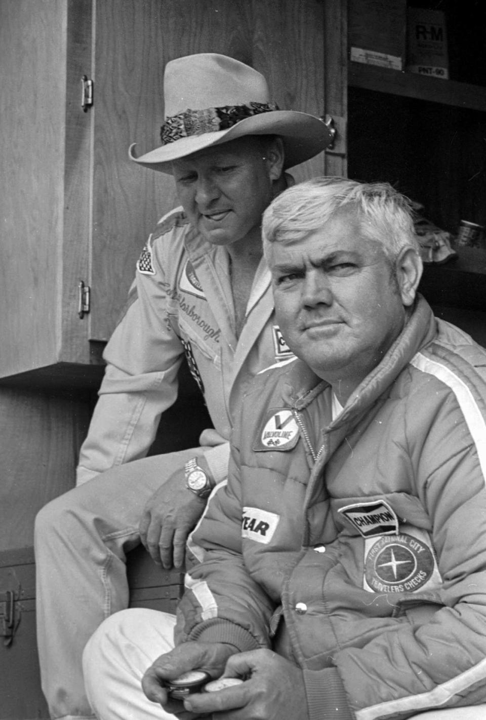 FILE - In this May 4, 1978, file photo, driver Cale Yarborough, left, and his team owner, former driver Junior Johnson, watch competitors in qualifying for the NASCAR Winston 500 auto race at Alabama International Motor Speedway in Talladega, Ala. Johnson, who won 50 NASCAR Cup Series races as a driver and 132 as an owner and was part of the inaugural class inducted into the NASCAR Hall of Fame in 2010, died Friday, Dec. 20, 2019, at 88. (AP Photo, File)