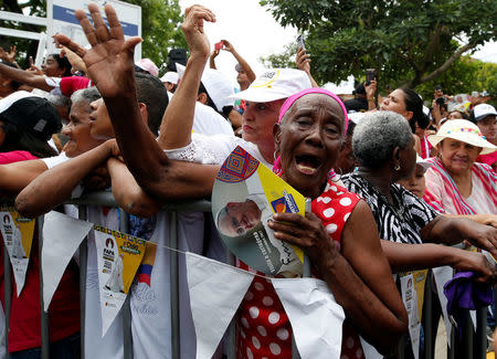 A faithful reacts as Pope Francis arrives in a neighbourhood in Cartagena, Colombia September 10, 2017. REUTERS/Stefano Rellandini