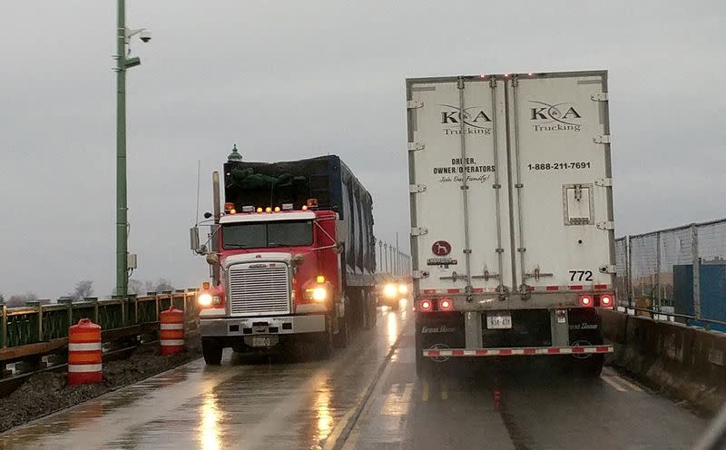 FILE PHOTO: Transport trucks cross paths on the Peace Bridge at the Canada U.S. border in Buffalo