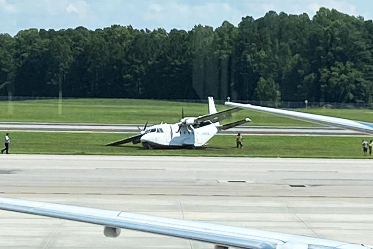 A twin-engine CASA CN-212 Aviocar is inspected following an emergency landing at Raleigh-Durham International Airport (Simon Palmore via Twitter)