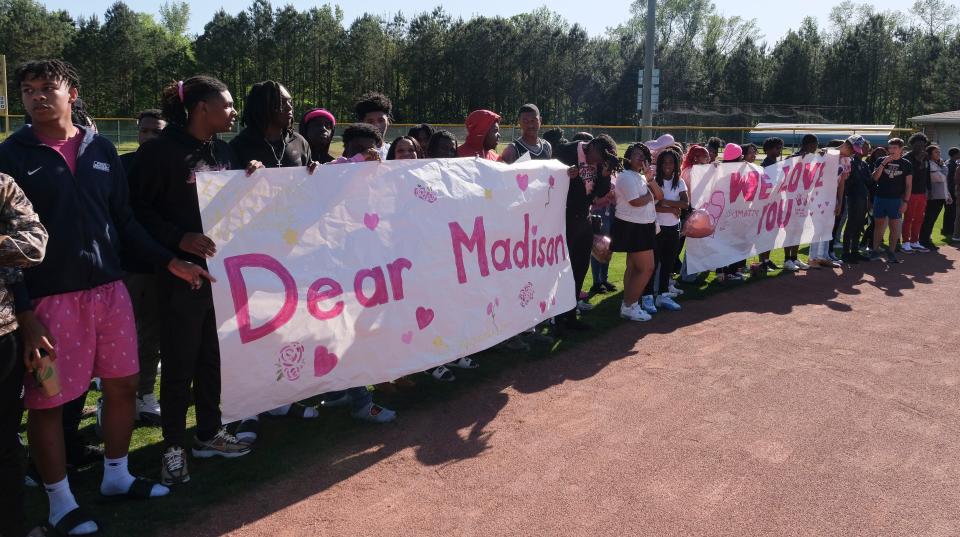 Students at Paul Bryant High gather and release balloons in memory of their classmate, Madison Sims, who was killed in a car wreck. 