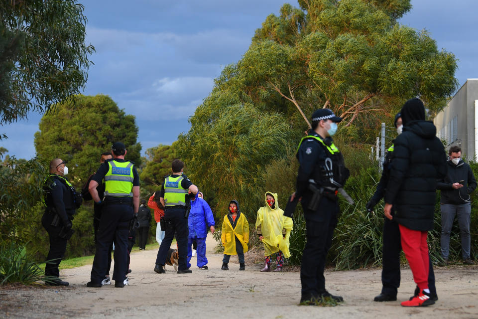 Victorian Police speak with people who are out walking near Dandenong's George Andrews Reserve on Thursday. Source: AAP