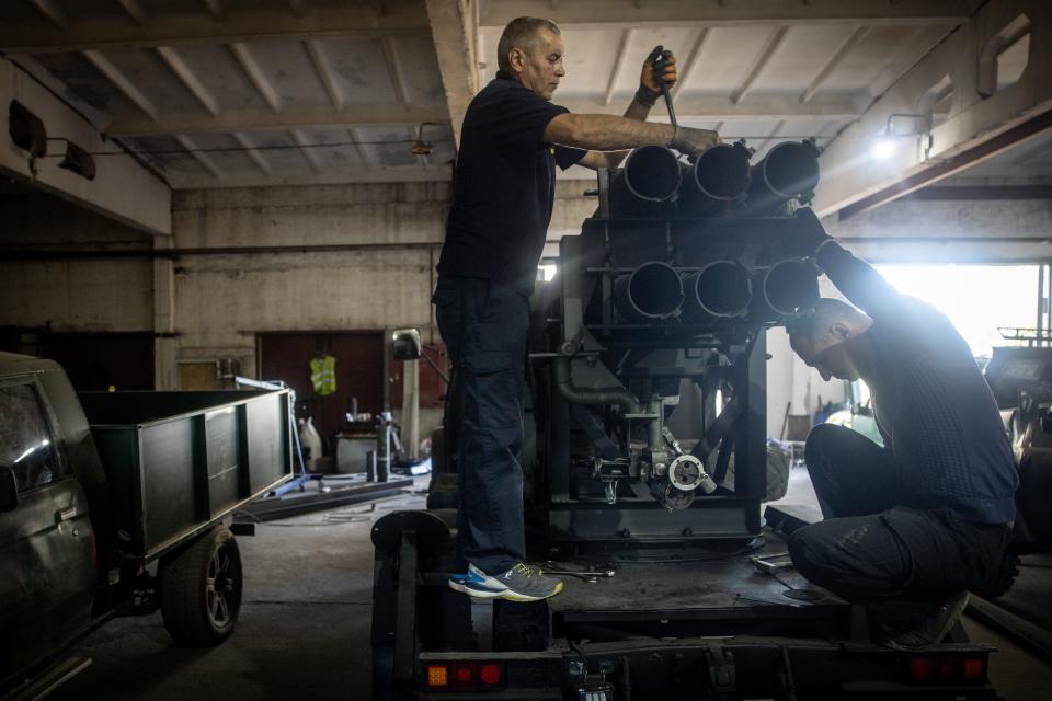 Ukrainian civilian volunteers work to modify damaged and salvaged vehicles into small mobile MLRS (Multiple Launch Rocket System) units made from recovered Russian and Ukrainian military hardware on September 25, 2023, in Zaporizhzhia, Ukraine.