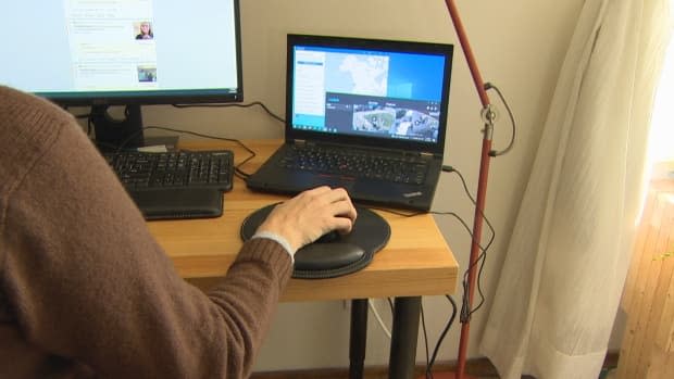 A Reddit moderator in Edmonton tackles a queue of misinformation targeting r/Alberta, a local community on the social media site. Three volunteer moderators say posts pushing misinformation and conspiracy theories about COVID-19 have surged in their online communities.  (Nathan Gross/CBC - image credit)