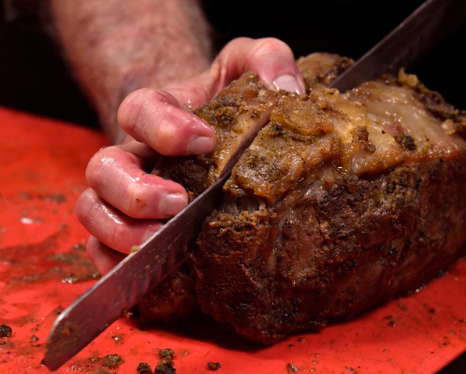 Ali Esfandiary slices a prime rib in the kitchen at the Albany Beehive, known formally as the Fort Griffin General Merchandise and Beehive Saloon.