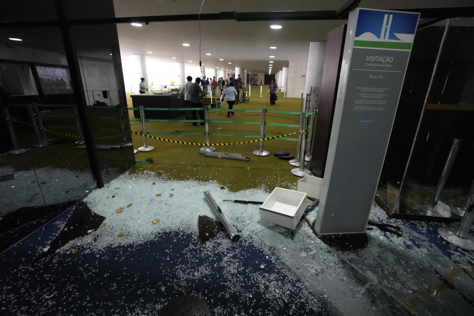 The Senate entrance is destroyed the day after Congress was stormed by supporters of former Brazilian President Jair Bolsonaro in Brasilia, Brazil, Monday, Jan. 9, 2023. The protesters also stormed the presidencial office, Planalto Palace, and the Supreme Court. (AP Photo/Eraldo Peres)