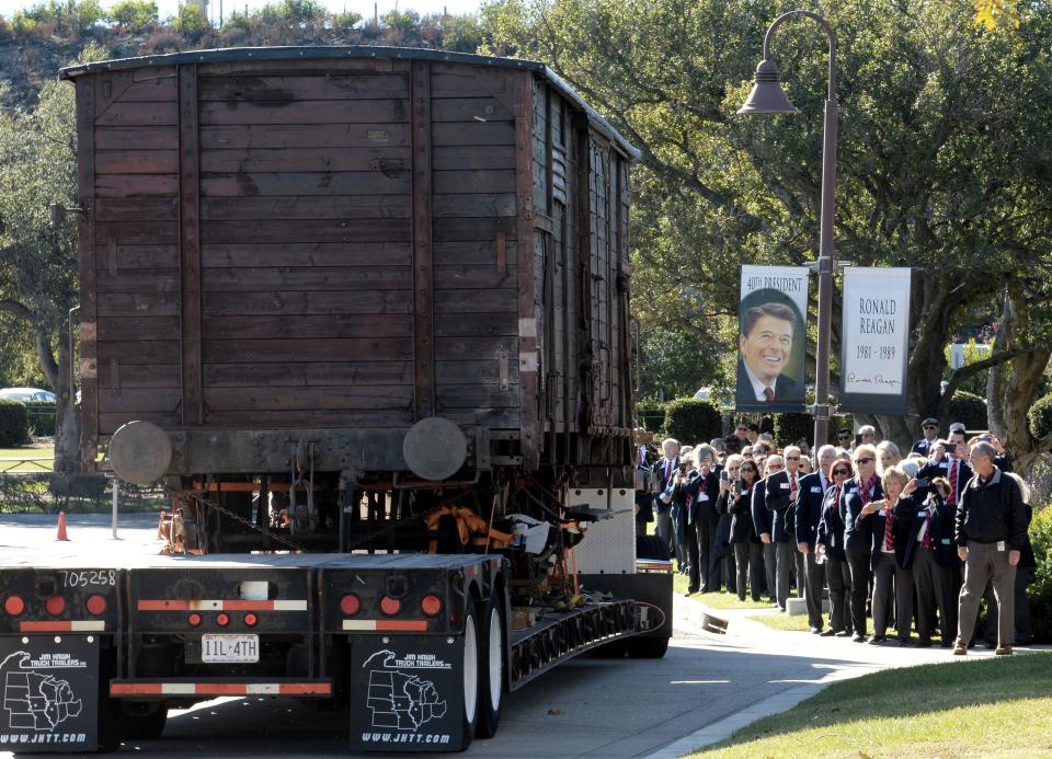 A Nazi freight train car like the ones used to transport Jews and others to the Auschwitz concentration camp arrives at the Ronald Reagan Presidential Library u0026 Museum on Thursday.