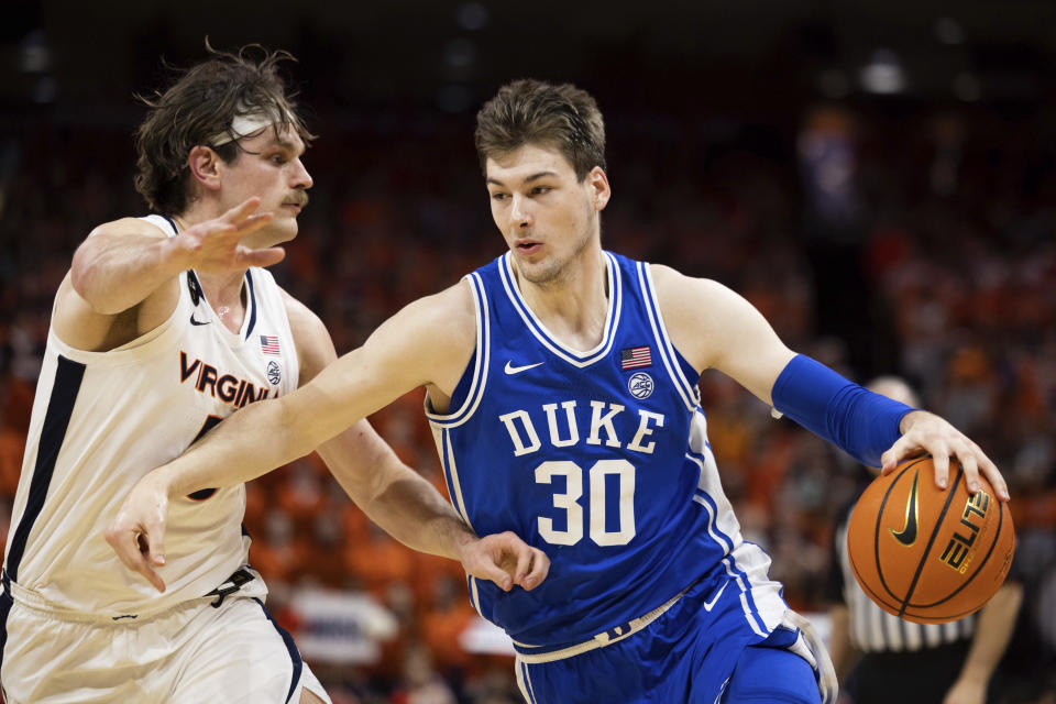 Duke's Kyle Filipowski (30) defends the ball against Virginia's Ben Vander Plas (5) during the first half of an NCAA college basketball game in Charlottesville, Va., Saturday, Feb. 11, 2023. (AP Photo/Mike Kropf)