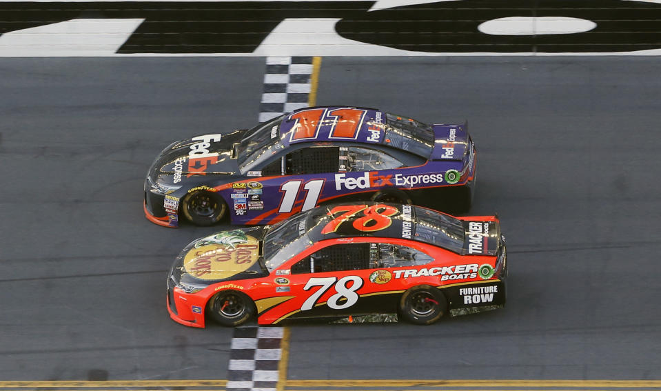 FILE - Denny Hamlin (11) beats out Martin Truex Jr. (78) at the finish line to win the NASCAR Daytona 500 auto race at Daytona International Speedway, Sunday, Feb. 21, 2016, in Daytona Beach, Fla. Truex Jr. is winless in 19 starts in the 500, none more agonizing than losing to Joe Gibbs Racing teammate Denny Hamlin by inches in 2016. (AP Photo/Wilfredo Lee, File)