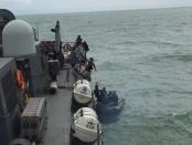 An Indonesian Navy seaboat (R) picks up items retrieved from the Republic of Singapore Navy vessel RSS Valour in this handout photo provided by Singapore's Ministry of Defence, released to Reuters January 4, 2015. REUTERS/Singapore Ministry of Defence/Handout via Reuters