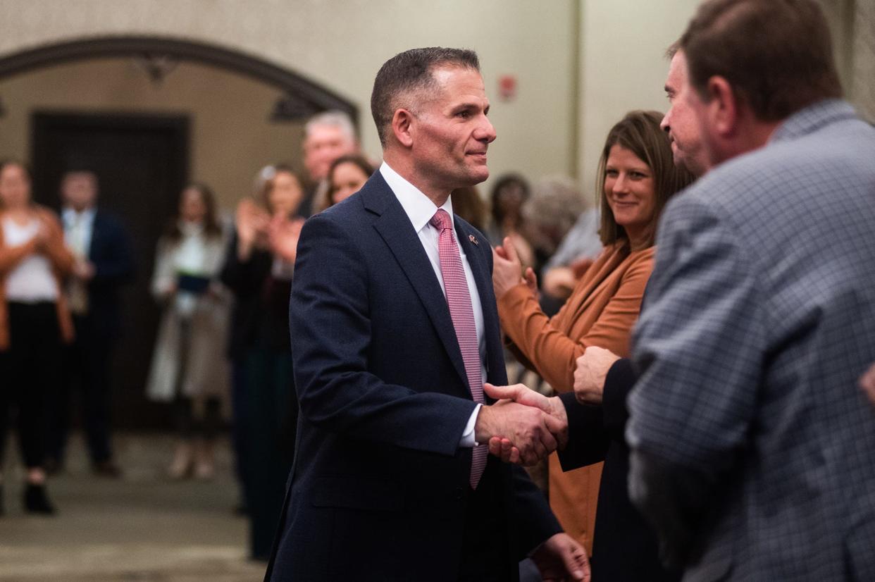 Rep. Marc Molinaro, left, shakes hands with Chris Gibson after being sworn in during the Ulster County swearing-in ceremony for Molinaro in Saugerties, NY, on Saturday, Jan. 22, 2023.