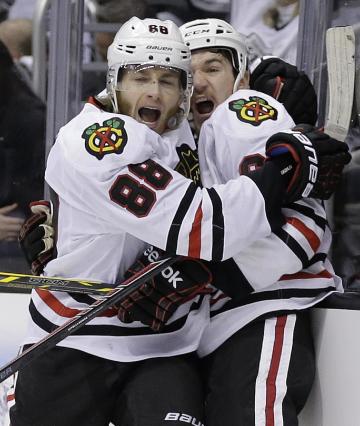 Patrick Kane, left, celebrates his tie-breaking goal with center Andrew Shaw. (AP)