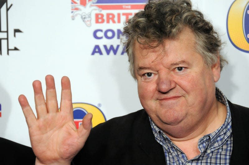 Robbie Coltrane waves hello at the 2011 British Comedy Awards.