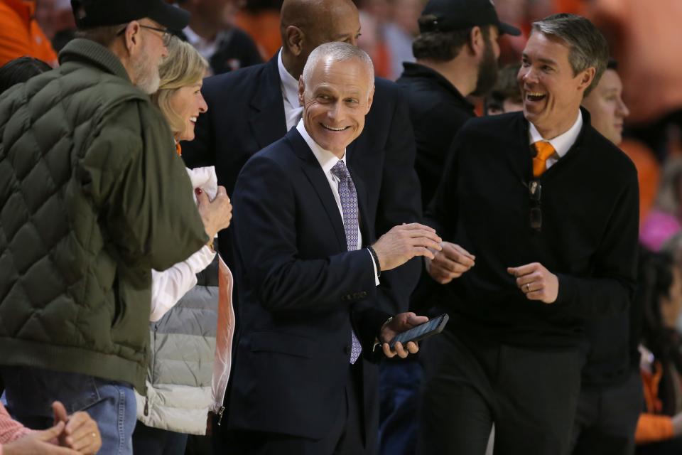 Big 12 commissioner Brett Yormark, center, and Oklahoma State athletic director Chad Weiberg, right, before a men's college basketball game between the Oklahoma State University Cowboys and the Kansas Jayhawks at Gallagher-Iba Arena in Stillwater, Okla., Tuesday, Feb. 14, 2023. 