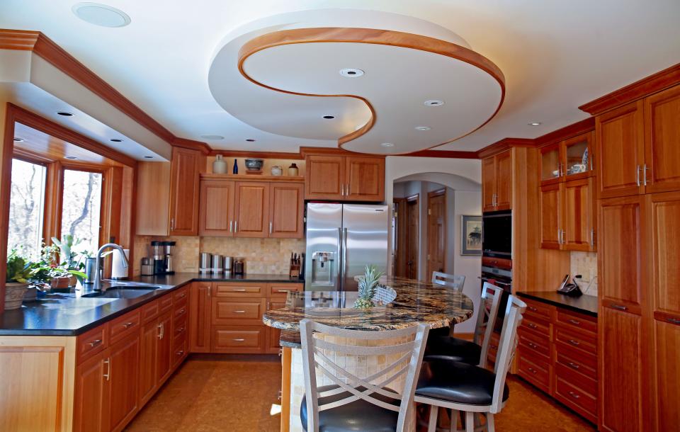The soffit and island are the main features in the kitchen of  Bayside homeowners Linda Even and husband Scott Kania. Also seen are cherry cabinets.  Over the course of 22 years they renovated every room in their house, doing most of the work themselves.