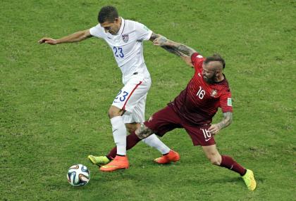 United States&#39; Fabian Johnson, left, is challenged by Portugal&#39;s Raul Meireles during the group G World Cup soccer match between the USA and Portugal at the Arena da Amazonia in Manaus, Brazil, Sunday, June 22, 2014. (AP Photo/Themba Hadebe)