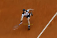 In this photo taken with a slow shutter speed, Andy Murray, from Britain, returns a ball against Gilles Simon, from France, during a Madrid Open tennis tournament match in Madrid, Spain, May 5, 2016. Murray won 6-4 and 6-2. (Francisco Seco/AP)