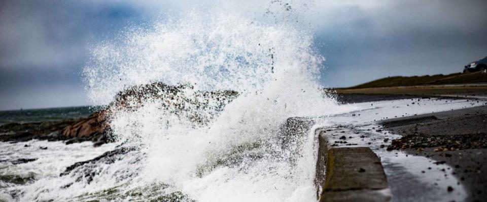 Waves and storm surge crash over Ocean Drive in Newport Rhode Island.