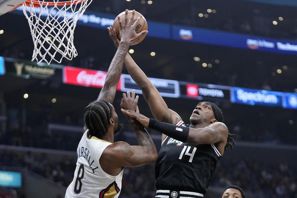 Los Angeles Clippers guard Terance Mann, right, shoots as New Orleans Pelicans forward Naji Marshall defends during the first half of an NBA basketball game Saturday, March 25, 2023, in Los Angeles. (AP Photo/Mark J. Terrill)