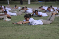 Special police officer recruits who completed nearly three months physical training perform yoga at Kathua in Indian-controlled Kashmir, Saturday, June 5, 2021. Special police officers are lower-ranked police officials who are mainly recruited for intelligence gathering and counterinsurgency operations. In recent years, the force has assisted in border areas as well because of local recruits' familiarity with the topography and ability to assist police and border guards during emergencies. (AP Photo/Channi Anand)