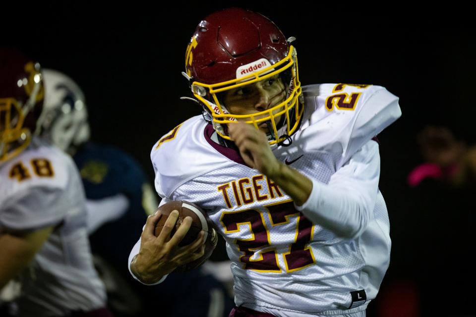 Junction City running back Levi Walker carries the ball for the Tigers. The Marist Spartans defeated the Junction City Tigers 21-7 at Marist High School Friday, Oct. 28, 2022, in Eugene. 