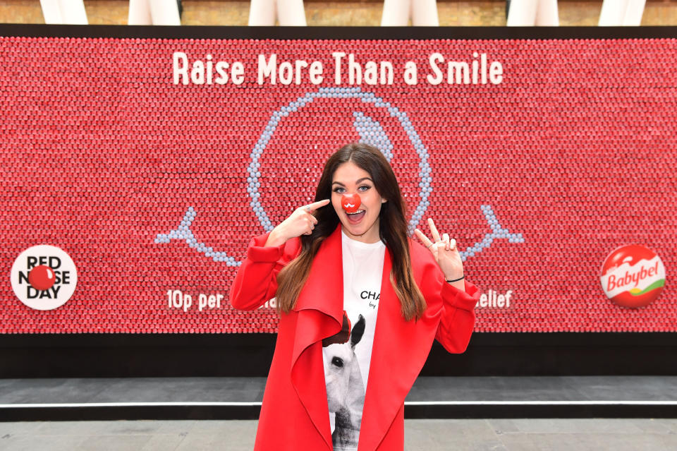  EDITORIAL USE ONLY
Scarlett Moffatt unveils a billboard made of special Red Nose Day editions of Mini Babybel, at King's Cross station in London. 