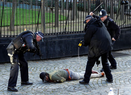 Armed police taser a man inside the grounds of the Houses of Parliament in London, Britain, December 11, 2018. REUTERS/Peter Nicholls