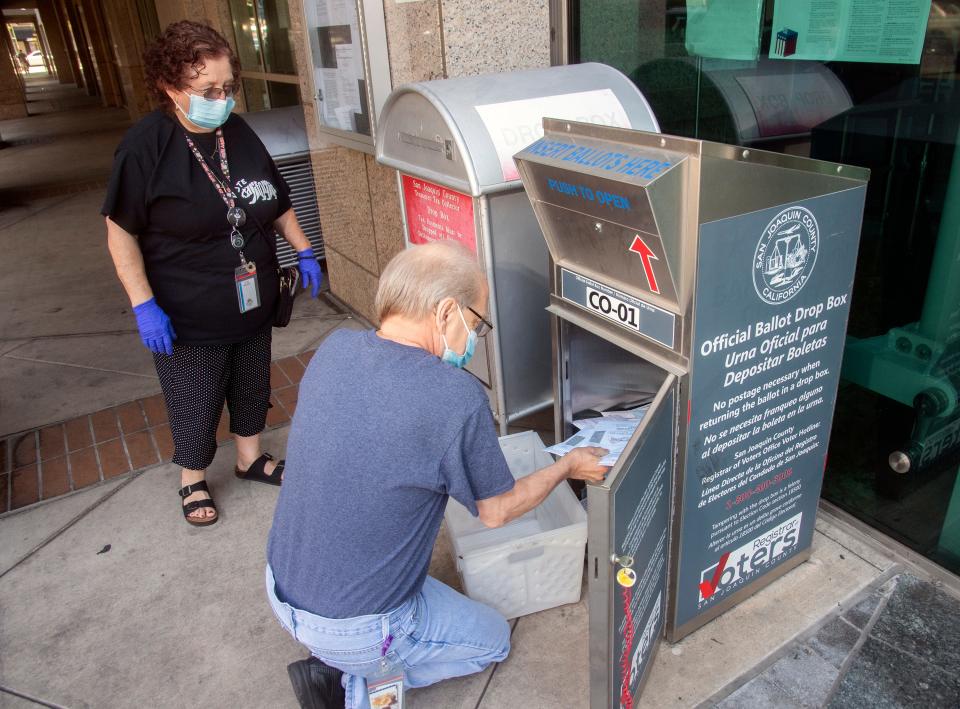 (6/6/22)Election works Charlotte Martin, left, and Ken Freimarck collects ballots from the ballot drop off box located in front of the San Joaquin County Administration Building on Weber Avenue and San Joaquin Street in downtown Stockton. CLIFFORD OTO/THE STOCKTON RECORD