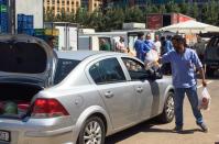 Men distribute free food to people in need, as an initiative from Lebanese businessman Fadi Khairo, in Beirut