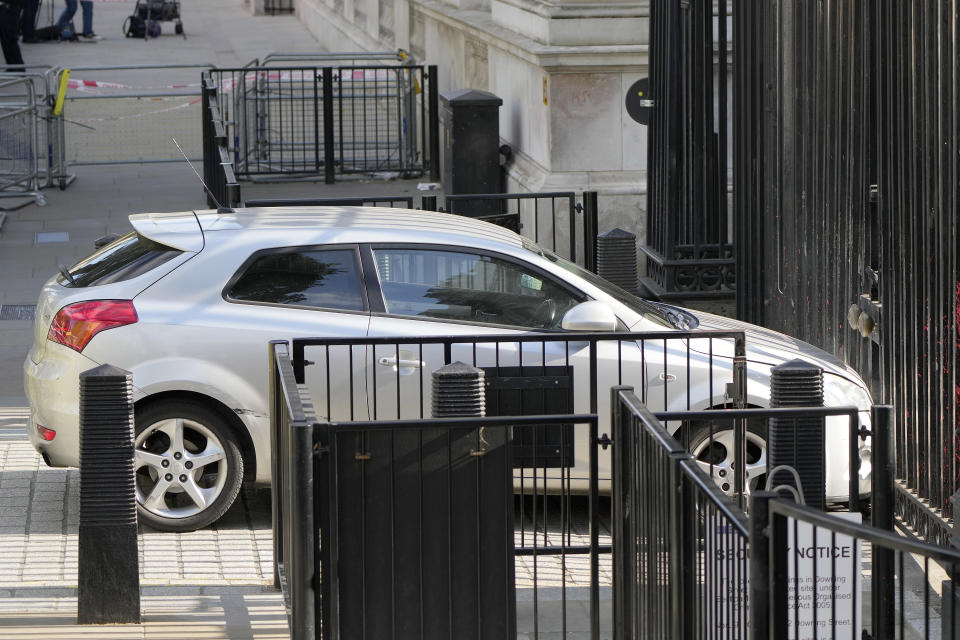 A car is stopped after colliding with the gates of Downing Street in London, Thursday, May 25, 2023. Police say a car has collided with the gates of Downing Street in central London, where the British prime minister's home and offices are located. The Metropolitan Police force says there are no reports of injuries. Police said a man was arrested at the scene on suspicion of criminal damage and dangerous driving. It was not immediately clear whether the crash was deliberate. (AP Photo/Alastair Grant)