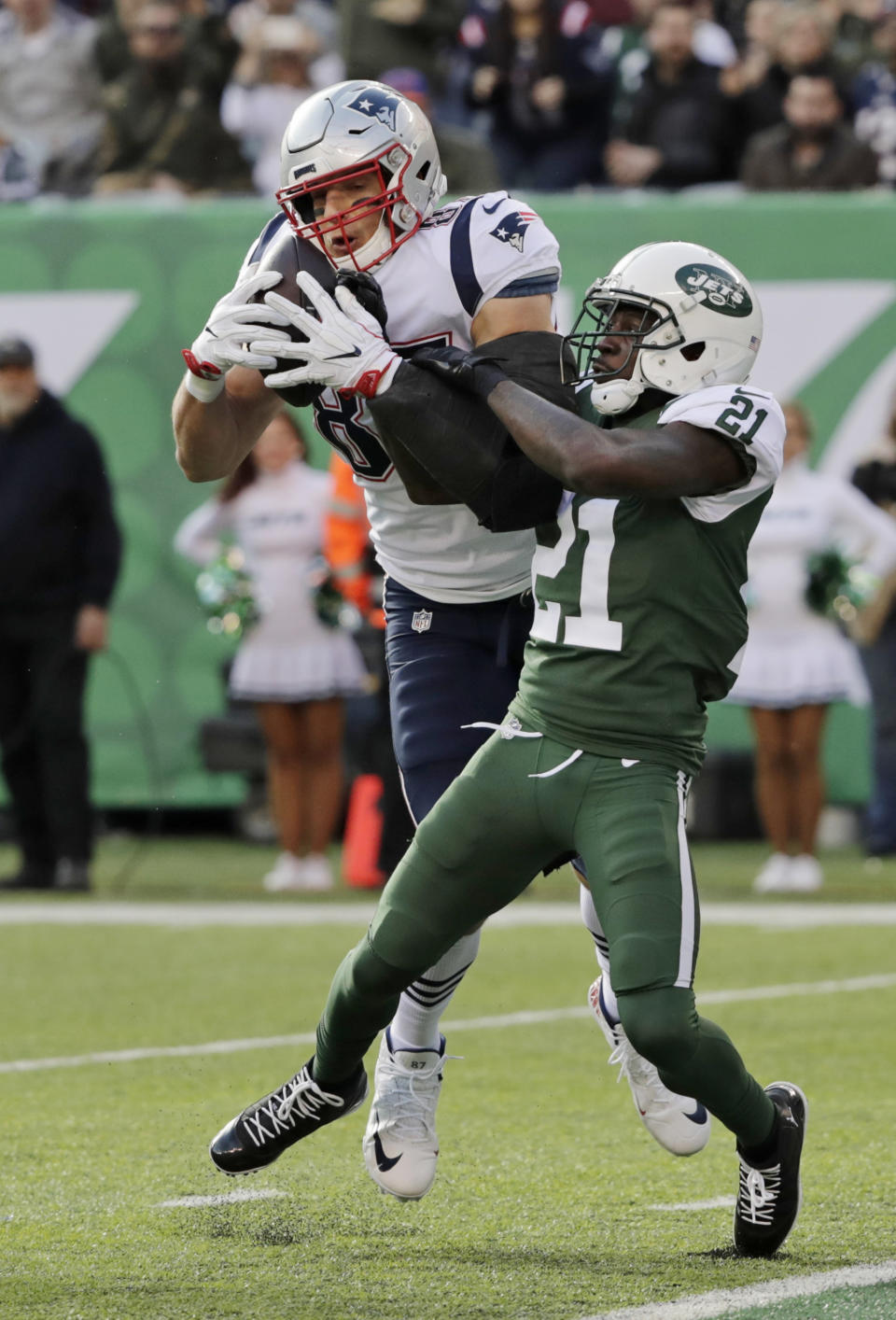 New York Jets cornerback Morris Claiborne (21) defends New England Patriots' Rob Gronkowski (87) during the first half of an NFL football game Sunday, Nov. 25, 2018, in East Rutherford, N.J. Gronkowski scored a touchdown on the play. (AP Photo/Bill Kostroun)