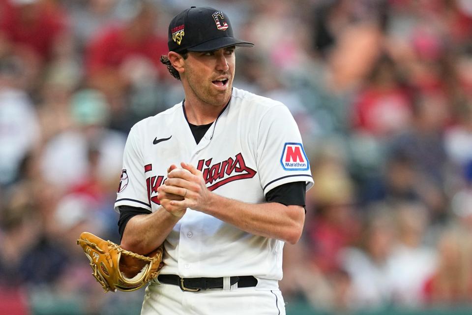 Cleveland Guardians starting pitcher Shane Bieber rubs up a new ball while Atlanta Braves' Ozzie Albies runs the bases on a home run during the fifth inning July 4 in Cleveland.