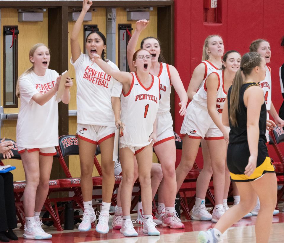 The Penfield bench celebrates a 3-pointer from Cassidy Cone.