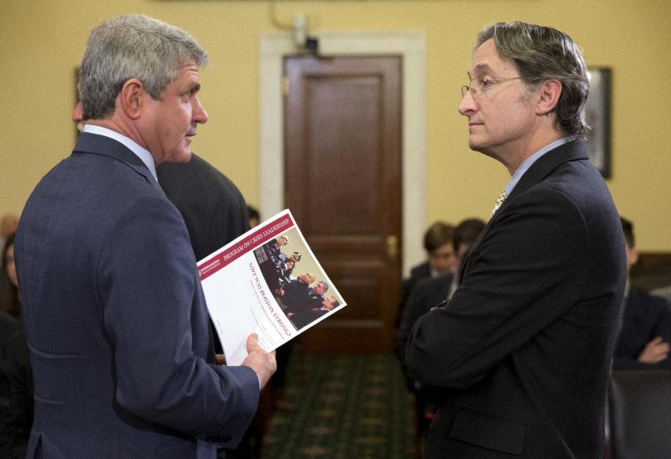 House Homeland Security Committee Chairman Rep. Michael McCaul, R-Texas, left, holds a document about the Boston Marathon Bombing by Harvard Professor Herman “Dutch” Leonard, right, on Capitol Hill in Washington, Wednesday, April 9, 2014, prior to the start of the committee's hearing on the bombings leading up to the year anniversary of the attack. (AP Photo/Jacquelyn Martin)