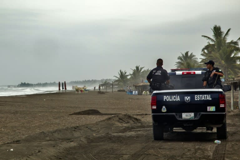 Police patrol the beach in Boca de Pascuales, Colima State, Mexico, on October 22, 2015 ahead of the arrival of fast-moving hurricane Patricia