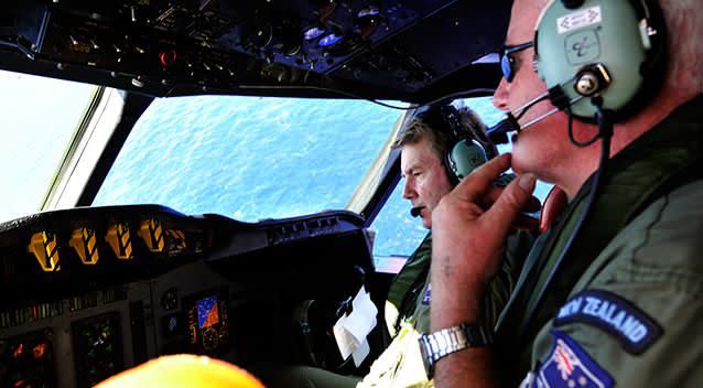 Royal New Zealand Air Force (RNZAF) co-pilot squadron leader Brett McKenzie, left, and Flight Engineer Trent Wyatt sit in the cockpit aboard a P-3 Orion on route to search over the southern Indian Ocean looking for missing Malaysia Airlines flight MH370. Photo: AP