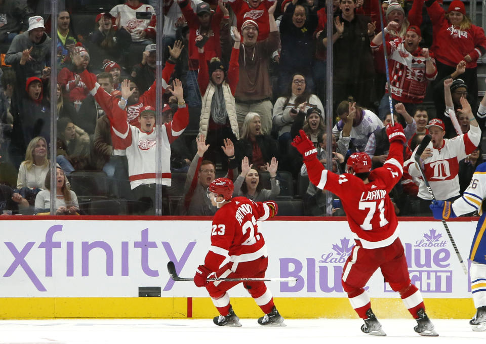 Detroit Red Wings right wing Lucas Raymond (23) celebrates his game-winning goal with center Dylan Larkin (71) during overtime of an NHL hockey game Saturday against the Buffalo Sabres, Nov. 27, 2021, in Detroit. (AP Photo/Duane Burleson)