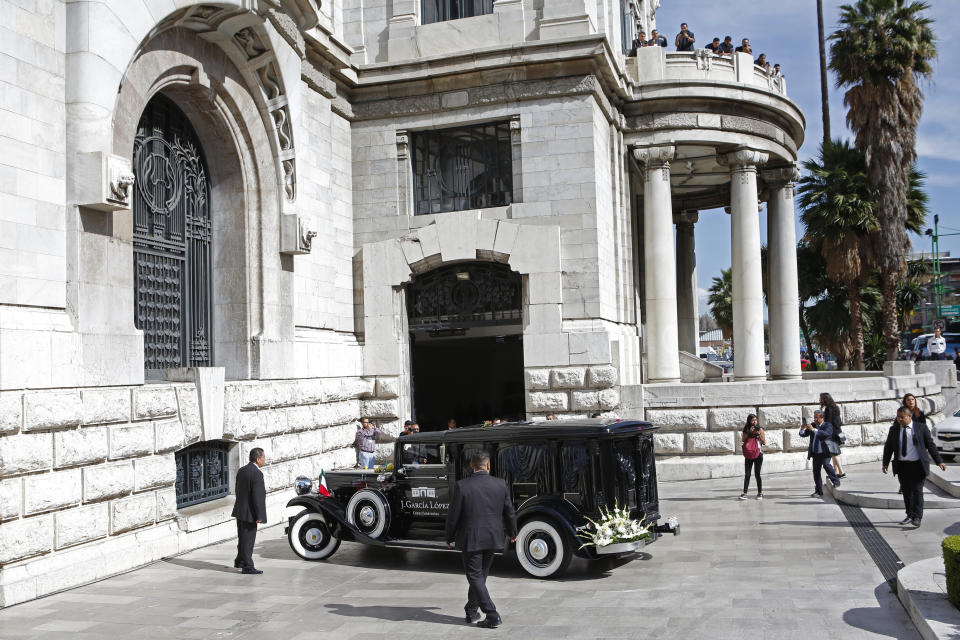 A hearse carrying ashes of Mexican singer Jose Jose arrives to the Palace of Fine Arts in Mexico City, Wednesday, Oct 9, 2019. Jose Jose died Sept. 28 in South Florida. His body was cremated in Miami, and it was agreed after a dispute among relatives over his remains, that half the ashes would remain there and the other half would be brought to Mexico. (AP Photo/Ginnette Riquelme)