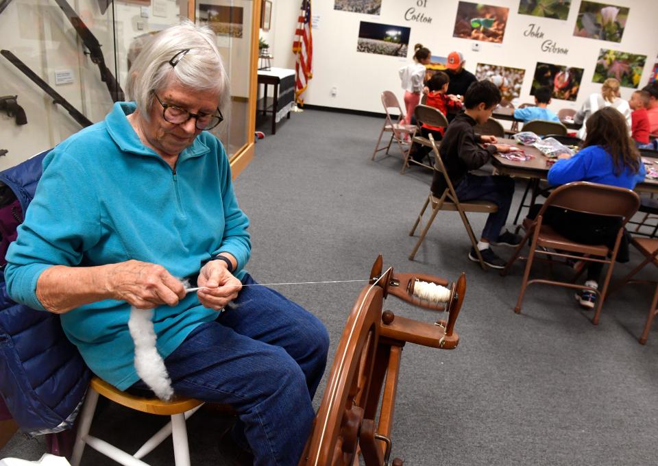 Marianne Marugg demonstrates spinning cotton into thread in Stamford.